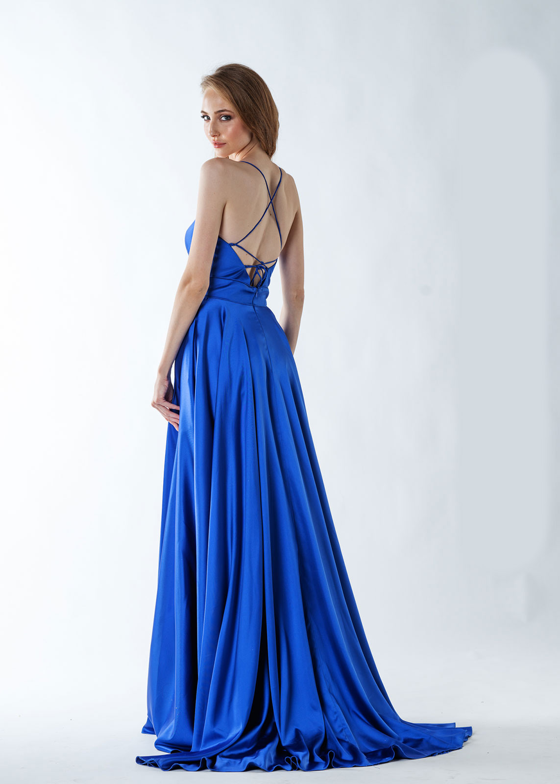 The rear of the truly elegant and flowng Madalina prom dress from MK Prom in Bletchley Milton Keynes in a fabulous sheer Royal blue satin fabric