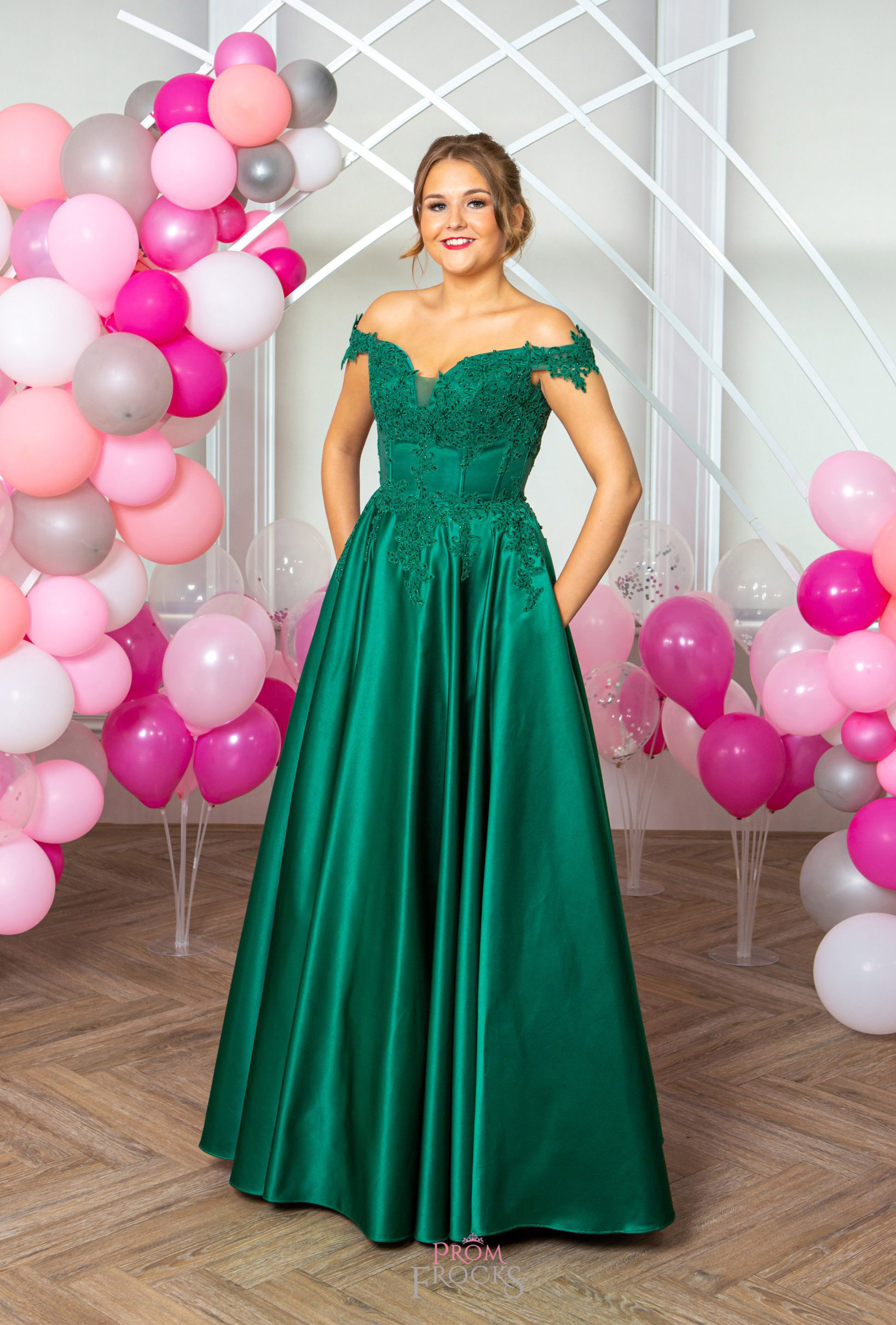 The front view of festive Francesca dress combining elegance with flair in vibrant Emerald green