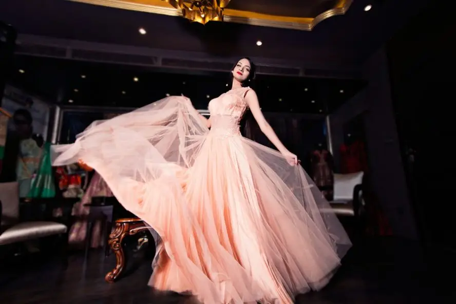 Model in an elegant evening dress, illustrating the Prom 2027 appointment season